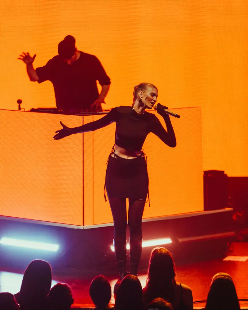 Live performance on an orange-lit stage