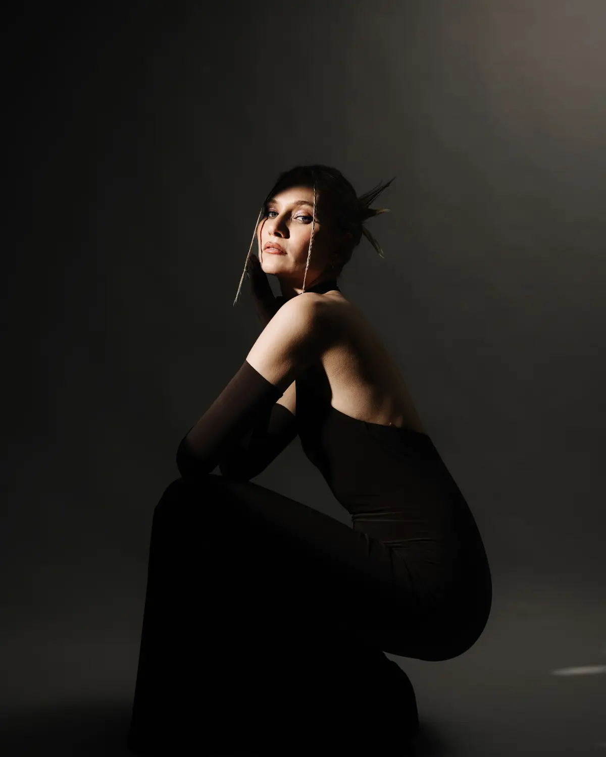 Editorial portrait in a dark studio